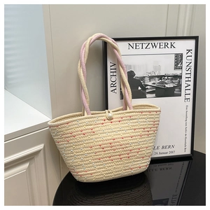 Detail of hand-woven straw bag with colorful polka dots, braided handle and pearl button
