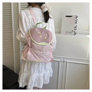 Detailed view of pink and lime green nylon backpack with Guava print and drawstring closure