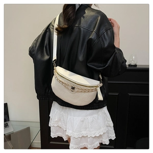 Detailed back view of white half-moon chest bag with skull embossing and gold chain