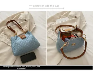 Detailed interior of quilted tote bag with brown handles showing storage for daily essentials