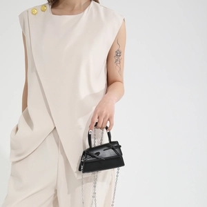 Mini black leather crossbody bag with bow accents and silver chain strap for women