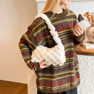 White fuzzy woven plush tote bag styled as a shoulder hobo bag for winter fashion