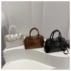 Three glossy leather Boston bags in white brown and black with buckle details
