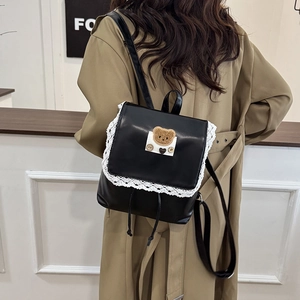 Vintage brown PU leather backpack with lace trim and cute bear patch on a female model