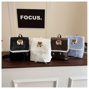 Detail of cute bear backpacks with lace trim and heart charms in four colors