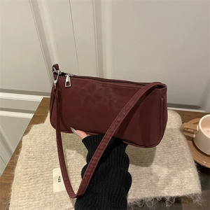 Minimalist burgundy underarm bag for women with matte nylon texture and silver zipper
