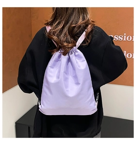 Detail of light purple waterproof nylon drawstring backpack with adjustable straps on back