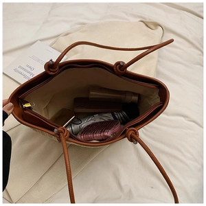 Top view of woven straw bag interior showing large capacity for umbrella and phone