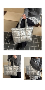 Detail view of silver quilted puffer tote bag with metallic finish and magnetic snap closure