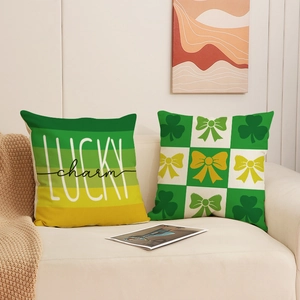 Set of 2 St. Patrick's Day green clover decorative pillow covers on a white sofa