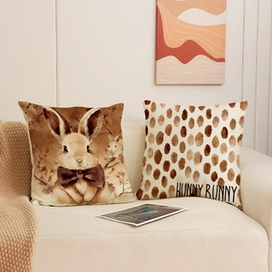 Easter linen pillow covers set featuring watercolor bunny and polka dot patterns on a sofa