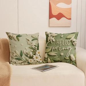 Floral and HELLO Spring embroidery pillow cases set on a sofa in a bright cozy living room