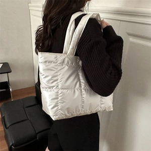 White quilted puffer tote bag with metallic finish for women's stylish winter commute