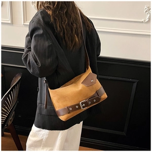 Close-up of ginger suede crossbody bag showing textured fabric and vintage leather straps