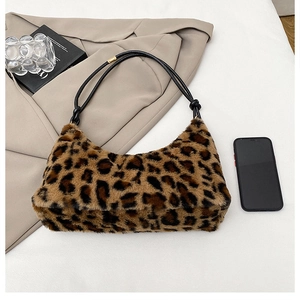 Detail of leopard print faux fur shoulder bag with black strap and golden ring