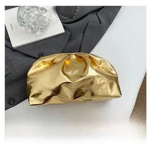 Detailed close-up of metallic gold ruched cloud bag with soft pleated texture and PU leather
