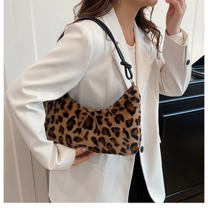Detail of plush leopard print faux fur shoulder bag with stylish black knotted strap