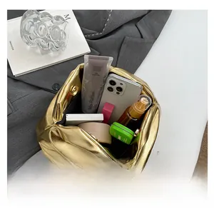 Top-down view of a metallic gold pleated cloud bag showing spacious interior capacity