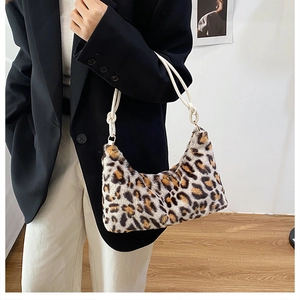 Detail of plush leopard print shoulder bag featuring textured faux fur and rope strap
