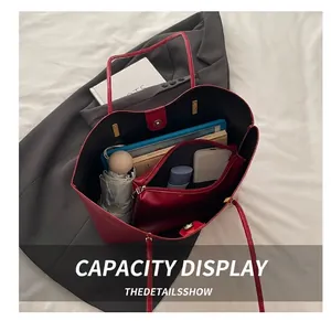 Detailed interior of red leather tote bag showing large capacity for tablet and daily items