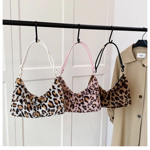 Three leopard print plush faux fur hobo bags in white, pink, and tan tones hanging together