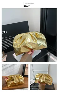 Detail shot of a shiny gold dumpling bag with elegant pleats and metallic texture