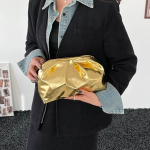 Metallic gold cloud clutch bag with ruched pleated design and luxury leather texture