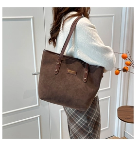 Close-up of the vintage dark brown matte leather tote bag with fine stitching details