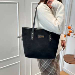Vintage black matte leather tote bag for women showing a spacious commute shoulder bag style
