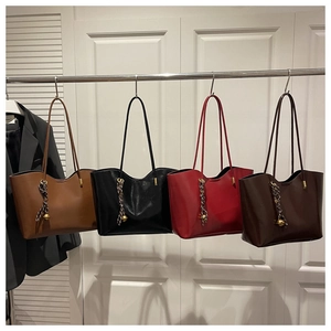 Four colors of leather tote bags with metal ball charms and silk scarf handle detail