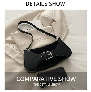 Detail of black crescent shoulder bag with silver buckle and phone for size reference