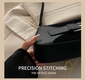 Close-up of precise stitching on black faux leather and suede shoulder bag detail