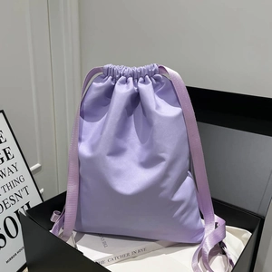 Chic lavender drawstring bucket bag made of satin fabric for women's shoulder or backpack use