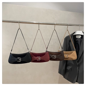 Row of minimalist large capacity shoulder bags in four versatile colors on a display rack