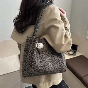 Vintage leopard print tote bag with green woven strap and plush ice cream charm on model
