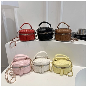 Selection of mini quilted cylinder bags in various colors with gold chain straps