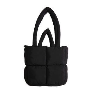 Minimalist black quilted puffer tote bag with square stitching and dual shoulder straps
