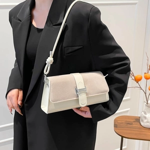 Minimalist beige crossbody bag with knotted strap and suede flap in French retro style