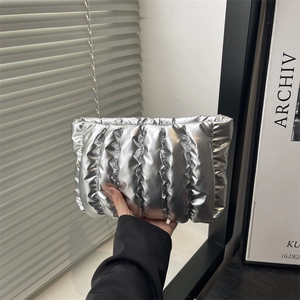 Metallic silver quilted clutch bag with winter fashion puffer texture for women