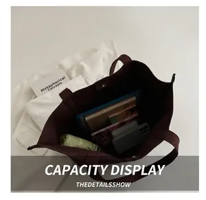 Interior view showing the large capacity of the burgundy rivet tote bag with magnetic clasp