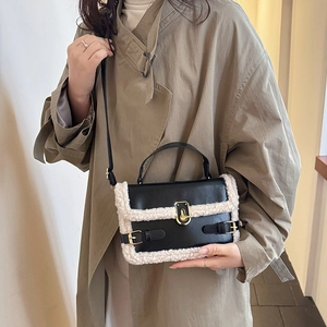 Chic black PU leather handbag with cream lamb wool trim and gold metal buckle