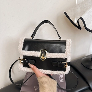 Chic black faux leather handbag with white plush sheepskin trim and gold lock detail