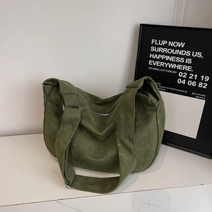 Minimalist large crescent tote bag in dark green suede with wide shoulder strap