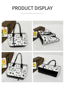 Detail of graffiti tote bag with cartoon prints and black PU leather straps in flat lay
