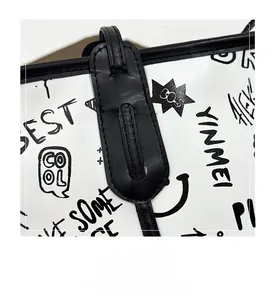 Detail of premium stitching on graffiti tote bag showing leather edges and handle joints