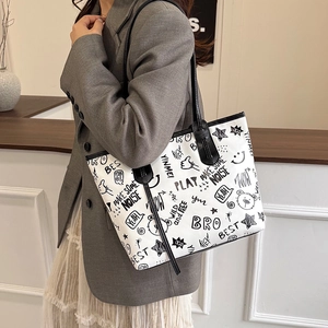 Graffiti print tote bag in white with cute cartoon patterns and black shoulder straps