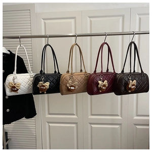 Detailed comparison of quilted tote bags in five colors with fuzzy monster charms