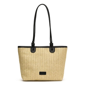 Minimalist woven straw tote bag with black leather straps for summer beach vacations