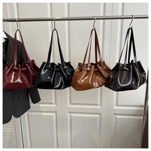 Detailed display of four glossy faux leather tote bags in burgundy black brown and coffee