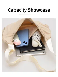 Large capacity nylon crossbody bag showing storage for a tablet, umbrella and phone